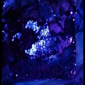 A pink and silver sequence pillow.